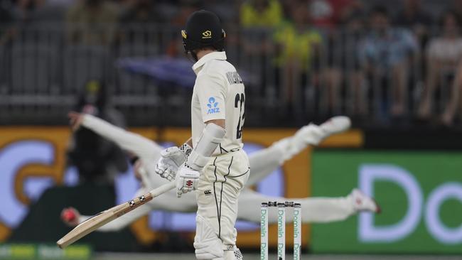 Kane Williamson looks behind as Steve Smith dives to catch him. Picture: AP