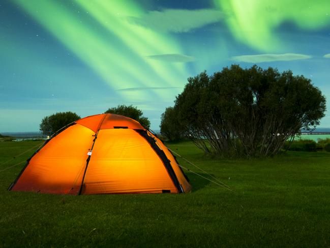 ESCAPE: ICELAND  ..  Aurora Borealis on Iceland, Lake Myvatn, red tent in foreground. Picture: iStock