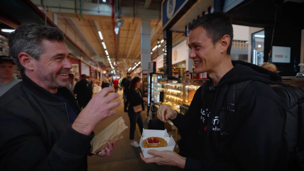 Wiens with Chef Nick (left) learning how to eat a pie. Picture: Mark Wiens / YouTube