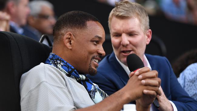 Will Smith speaking with Jim Courier on Rod Laver Arena at the Australian Open in 2018. Picture: Lukas Coch