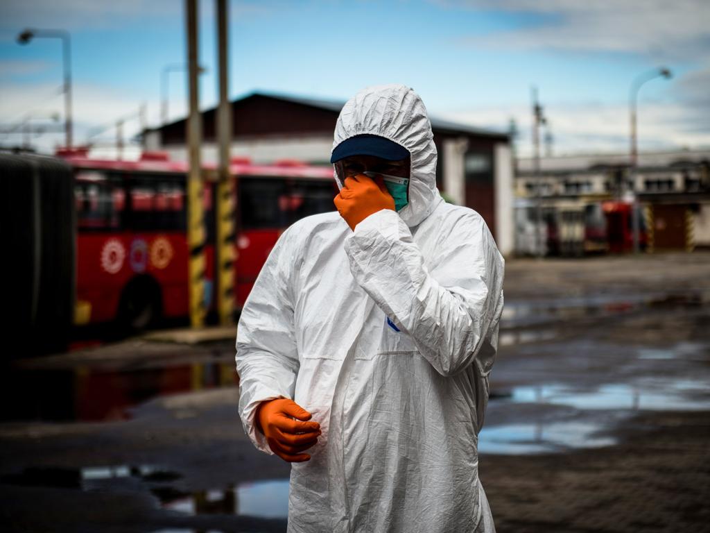 A worker gets ready to disinfect a bus in Bratislava. Picture: Vladimir Simicek/AFP