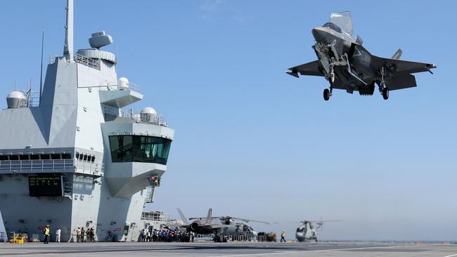 A Lockheed Martin F-35B Lightning II Joint Strike Fighters from Britain's Royal Air Force (RAF) No. 617 Squadron landing on the Royal Navy's aircraft carrier HMS Queen Elizabeth ahead of Exercise Strike Warrior.