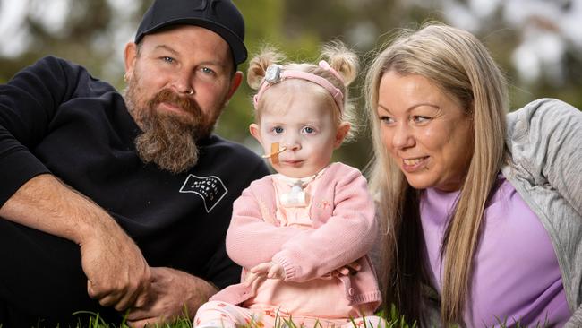 Kaiah Maloney, 20 months, is thriving after her rocky start to life; and (right) with parents Denis Maloney and Chantelle Colafella. Picture: Mark Stewart