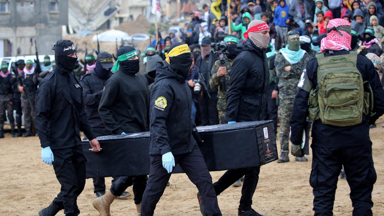 Palestinian militants carry one of the coffins.