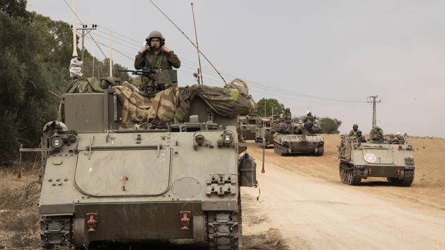 Israeli armoured personnel carriers drive toward the Israeli southern border with the Gaza Strip. Picture: Getty Images.