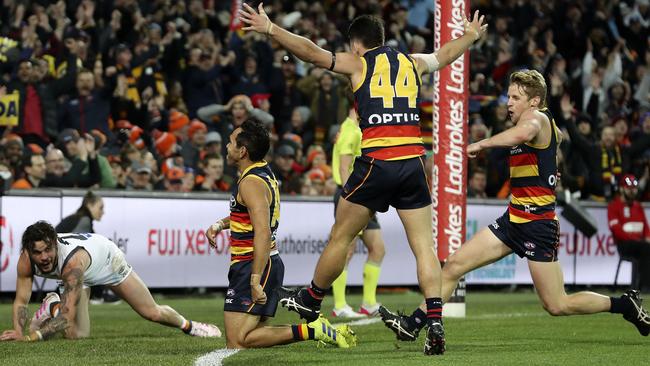 Rory Sloane and Lachie Murphy celebrate with Eddie Betts after his boundary-line goal against the Giants in Round 12. Picture SARAH REED