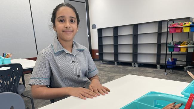 Anaheet, 10, checking out the library at her new school. (Picture: Olivia Condous)