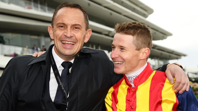 Chris Waller poses with jockey James McDonald after winning a Group 1 at Flemington. Picture: AAP