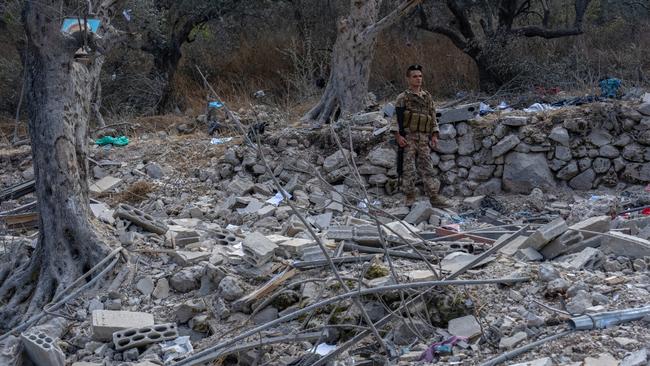 A soldier standing among the ruins of a house in Aitou. Picture: Carl Court/Getty Images