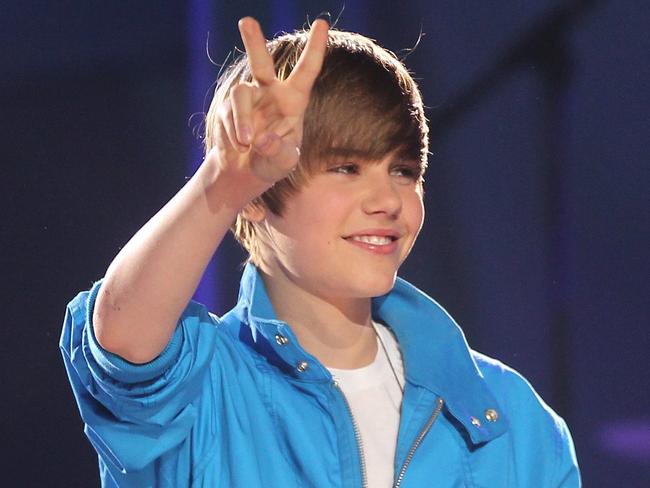 Justin Bieber gestures towards the crowd while performing during the Juno Awards in St. John's, Canada, on Sunday April 18, 2010. (AP Photo/The Canadian Press, Mike Dembeck)