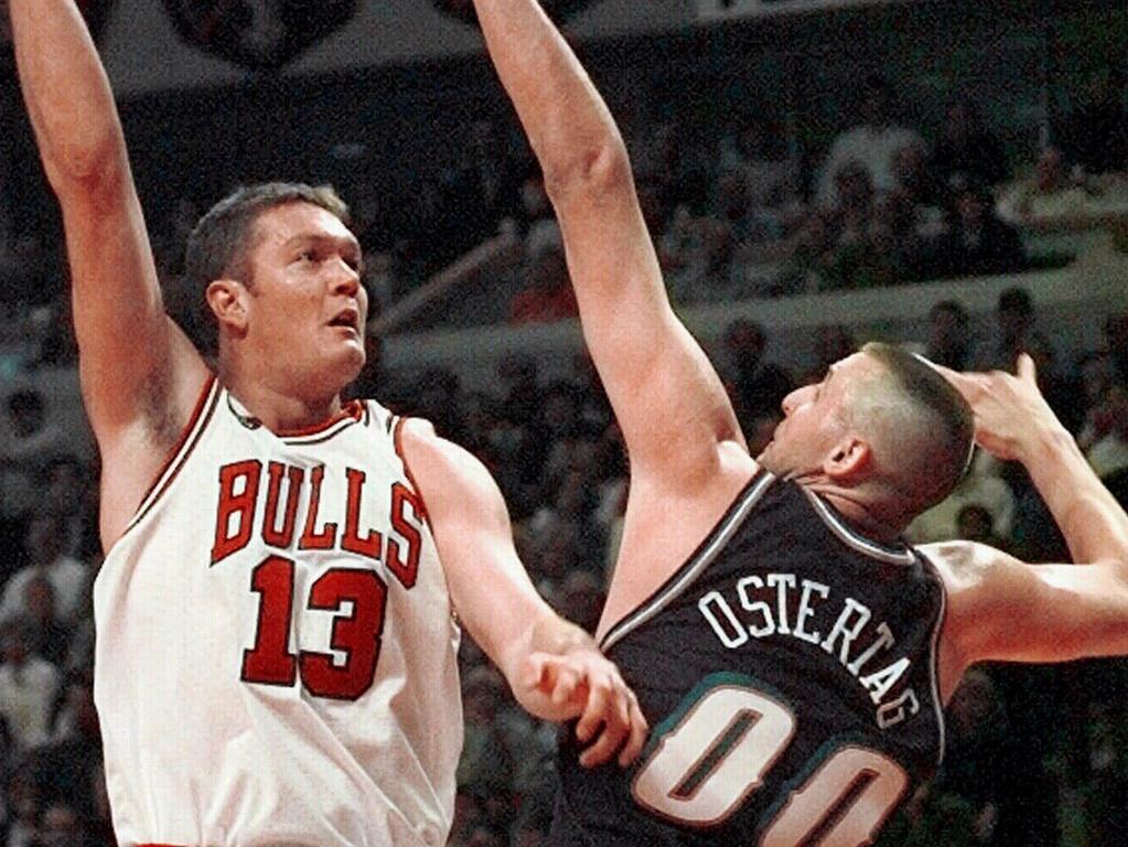 Luc Longley (13) shoots over top of Greg Ostertag during game 3 of Chicago Bulls v Utah Jazz NBA finals.