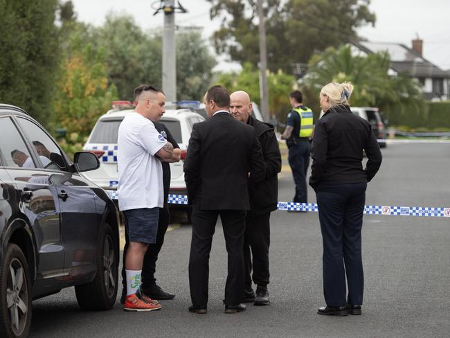 Detectives chat with Mr Latorre’s family members outside his Greenvale home. Picture: Nicki Connolly