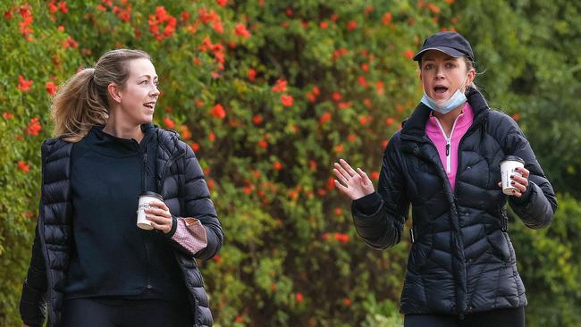 As it stands, someone can’t drink a beer on their walk after work but can drink a morning coffee surrounded by a crowd at a cafe. Picture : Ian Currie