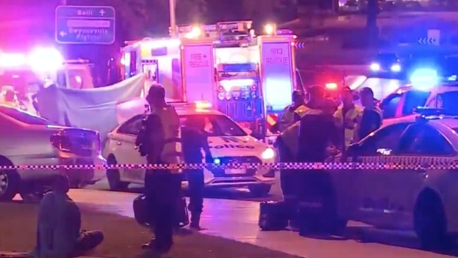 Police and paramedics treat the injured outside Collegians. Picture: 9 News