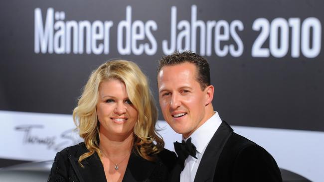 Michael Schumacher and his wife Corinna arrive for the GQ gala Men of the Year event. AFP PHOTO / JENS KALAENE.