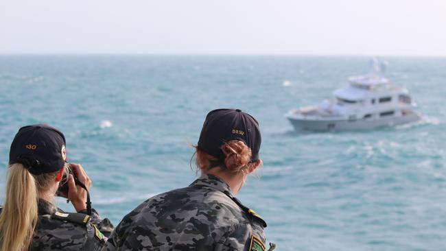 Officer of the Watch Sub Lieutenant Cameron Moncrieff and Assistant officer of the Watch Midshipman Eleanor Martin keep a watch over the maritime rescue of crew from MY Vivierae II off the coast of Northern Australia.