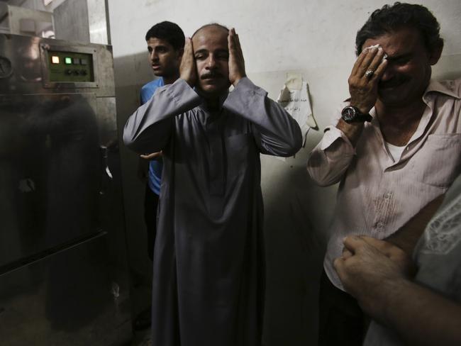 Palestinian relatives mourn in the morgue of Shifa hospital following an explosion that killed 10 people. Picture: Adel Hana