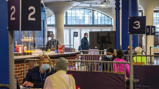 People sit in booths as they receive their vaccine in a special site in Boston, US. Picture: AFP