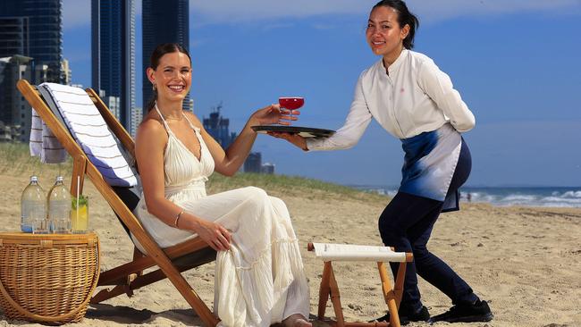 Jessica Sims with Yuri Ketsuriyong enjoys the beachfront at the front of The Langham on the Gold Coast. Pic: Adam Head