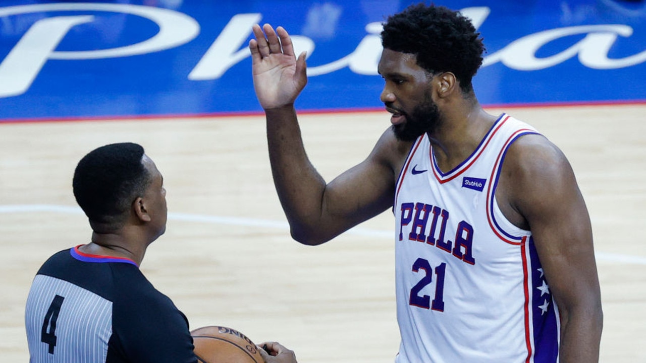 PHILADELPHIA, PENNSYLVANIA - JUNE 20: Joel Embiid #21 of the Philadelphia 76ers speaks with referee Sean Wright #4 during the second quarter during Game Seven of the Eastern Conference Semifinals between the Philadelphia 76ers and the Atlanta Hawks at Wells Fargo Center on June 20, 2021 in Philadelphia, Pennsylvania. NOTE TO USER: User expressly acknowledges and agrees that, by downloading and or using this photograph, User is consenting to the terms and conditions of the Getty Images License Agreement. (Photo by Tim Nwachukwu/Getty Images)