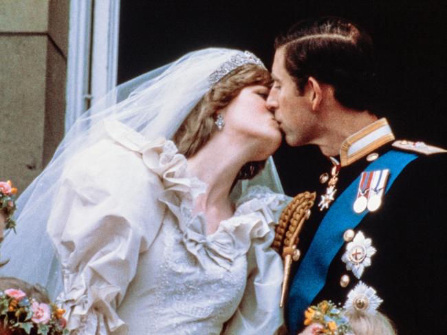 Charles, Prince of Wales, kisses his bride, Lady Diana, on the balcony of Buckingham Palace when they appeared before a huge crowd, on July 29, 1981, after their wedding in St Paul's Cathedral. Picture: AFP