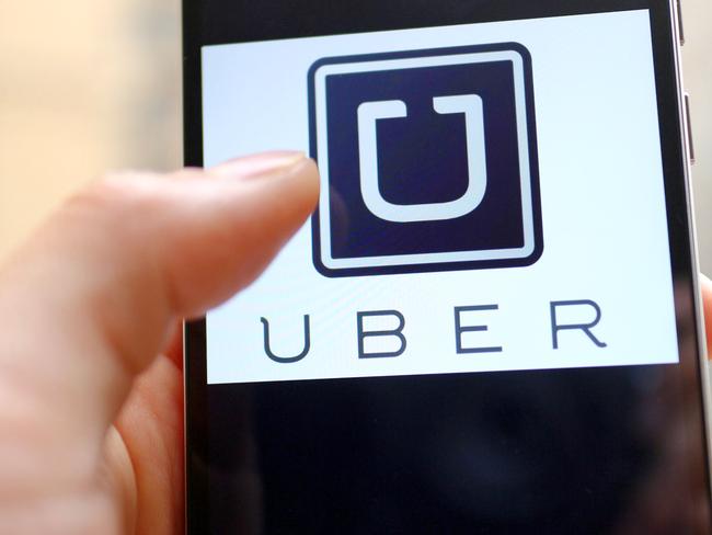 --FILE--A mobile phone user shows the logo of car-hailing app Uber on his smartphone in Chengdu city, southwest China's Sichuan province, 6 May 2015. U.S. firm Uber Technologies Inc and Chinese rival Didi Kuaidi are taking steps to operate legally in China, a key market for both firms but where their car hailing services currently operate in a regulatory prey zone. Uber China said in a statement on Thursday (8 October 2015) it was "actively preparing" documents to apply for a license to operate an online car-hailing platform to meet new regulations governing the sector that are expected to be announced soon. Didi Kuaidi, a $16 billion valued firm backed by Chinese Internet giants Alibaba Group Holding Ltd and Tencent Holdings Ltd, also said on Thursday it had received a car booking license for its operations in Shanghai and that it was seeking more licenses from other cities.