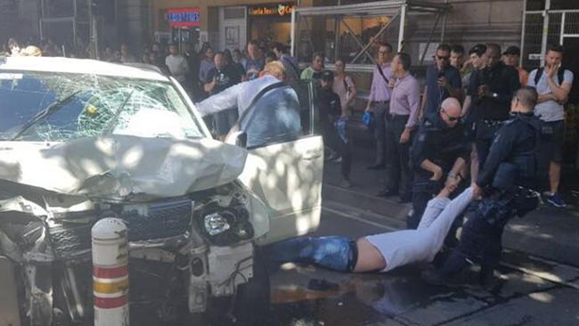 The driver of the Suzuki Grand Vitara is hauled from his car by police. Picture: Channel Seven