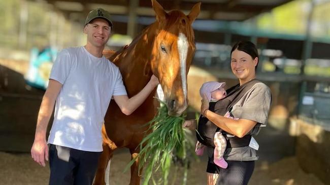 Trainer Clayton Douglas with his baby daughter Isla and partner Lydia Rigg-Floyd, with 2022 The Everest champion Giga Kick. Picture: Supplied