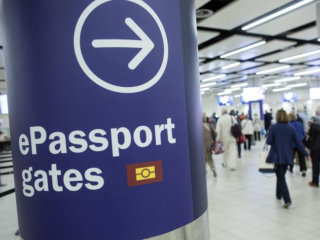 LONDON, ENGLAND - MAY 28: Passengers arriving at Gatwick Airport use the 'ePassport gates' at Passport Control on the UK Border on May 28, 2014 in London, England. Border Force is the law enforcement command within the Home Office responsible for the security of the UK border by enforcing immigration and customs controls on people and goods entering the UK. Border Force officers work at 140 sea and airports across the UK and overseas. (Photo by Oli Scarff/Getty Images)