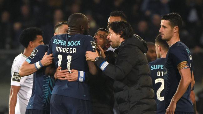 Marega attempts to leave the pitch after hearing racists chants, but is stopped by coach Sergio Conceicao. Picture: AFP