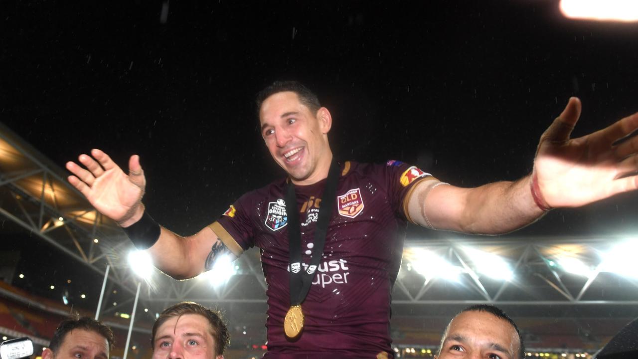 Billy Slater of the Maroons is chaired from the field by Cameron Munster (left) and Will Chambers