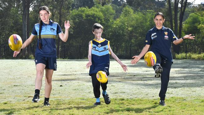 Chloe Marquis, Karl and AFLW player Courtney Hodder at Mabel Park State High School. The Brisbane Lions are making moves to introduce Aussie rules to the community through schools. Thursday August 4, 2022. Picture, John Gass