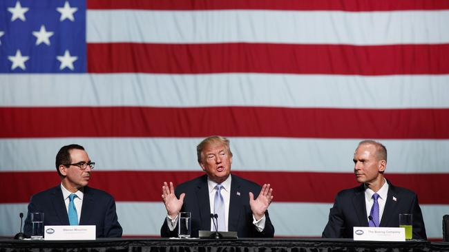 Treasury Secretary Steven Mnuchin, left, and Boeing CEO Dennis Muilenburg, right, with US President Donald Trump during a roundtable discussion. Picture: Evan Vucci
