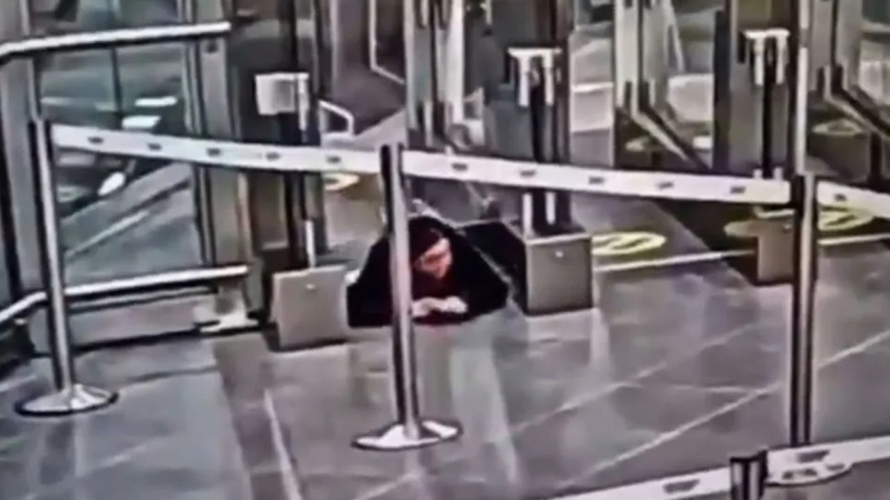 The moment the unnamed woman checks around to see if anyone is watching her, before she pulls off her airport stunt. Picture: CZ/newsX