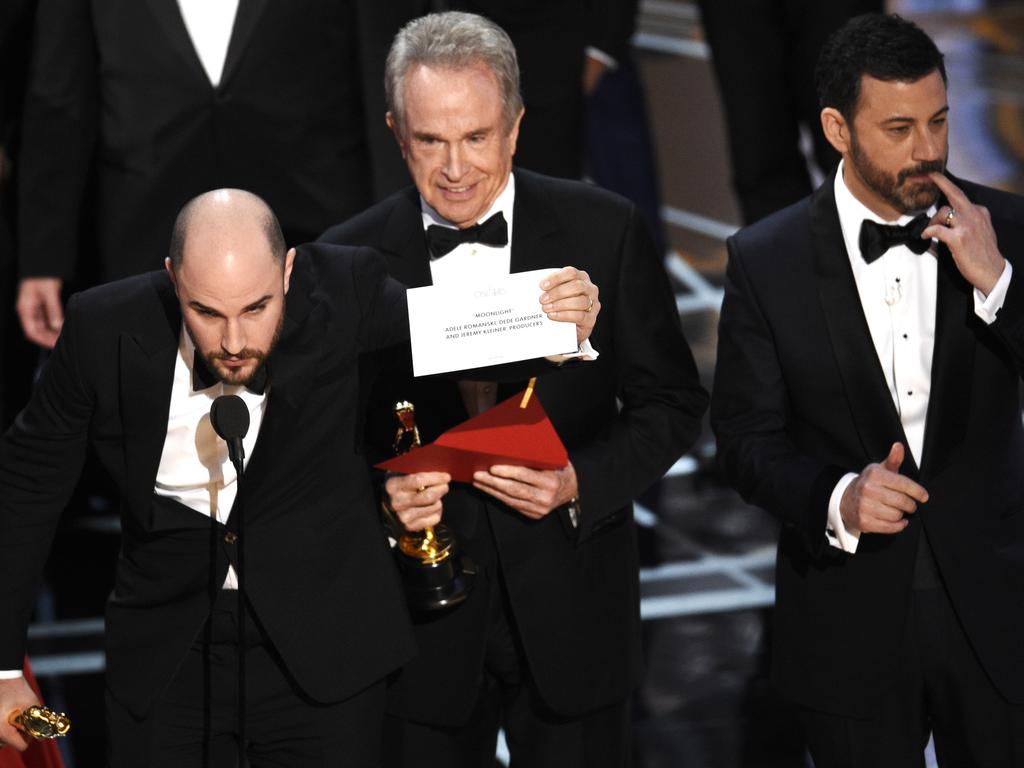 Jordan Horowitz shows the envelope revealing "Moonlight" as the true winner of best picture at the Oscars on Sunday, Feb. 26, 2017, at the Dolby Theatre in Los Angeles. Host Jimmy Kimmel and presenter Warren Beatty look on from right. (Photo by Chris Pizzello/Invision/AP)