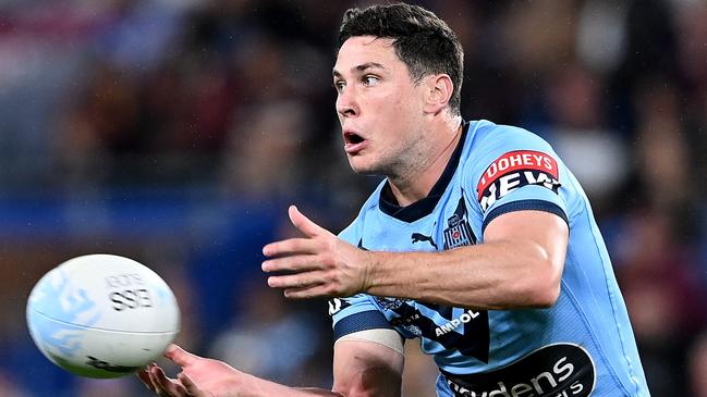 GOLD COAST, AUSTRALIA – JULY 14: Mitchell Moses of the Blues offloads the ball during game three of the 2021 State of Origin Series between the New South Wales Blues and the Queensland Maroons at Cbus Super Stadium on July 14, 2021 in Gold Coast, Australia. (Photo by Bradley Kanaris/Getty Images)