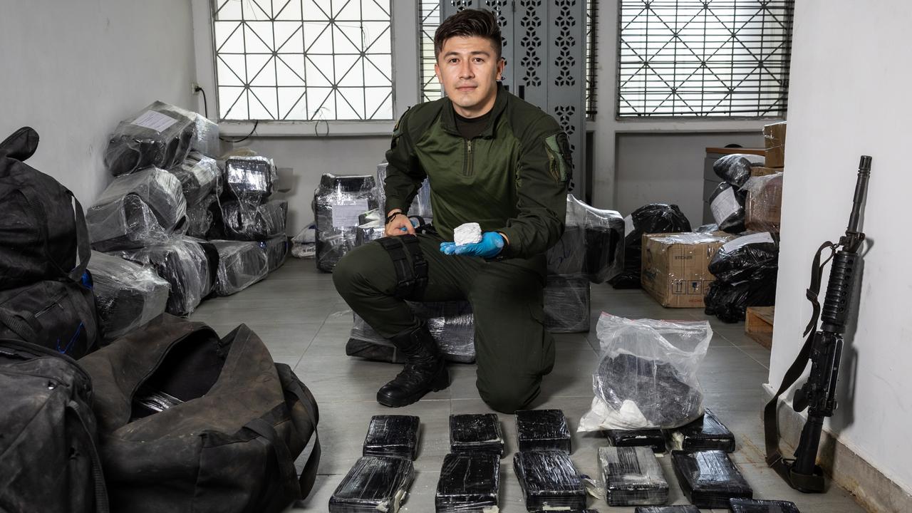 Patrol officer Jorge Vega with 800 kilograms of cocaine at a secure location in Cartagena, Colombia. The drugs have a wholesale value of $300,000 per kilogram, which equates to at least $240m. Picture: Jason Edwards