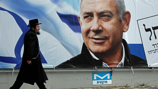 A man walks past a billboard for Benjamin Netanyahu’s campaign in Jerusalem. Picture: AFP