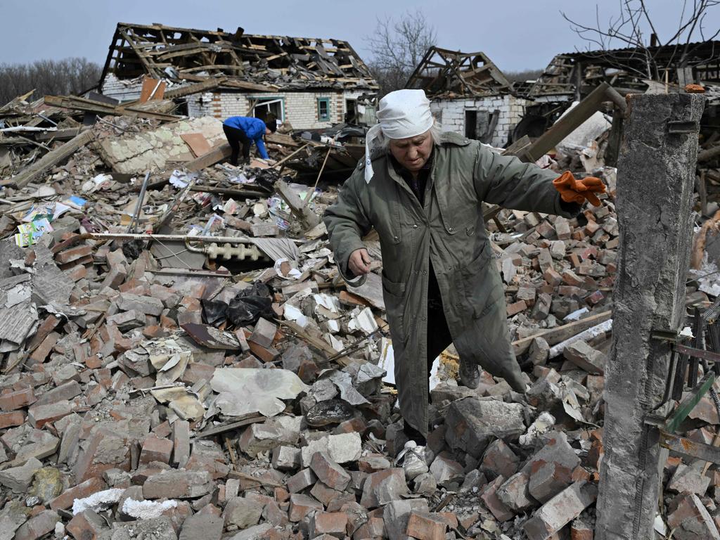 Svitlana Zavaly, 67, walks over the rubble of her house destroyed by a Russian bomb in the village Velyka Pysarivka, which lies just five kilometres from the Russian border. Picture: AFP