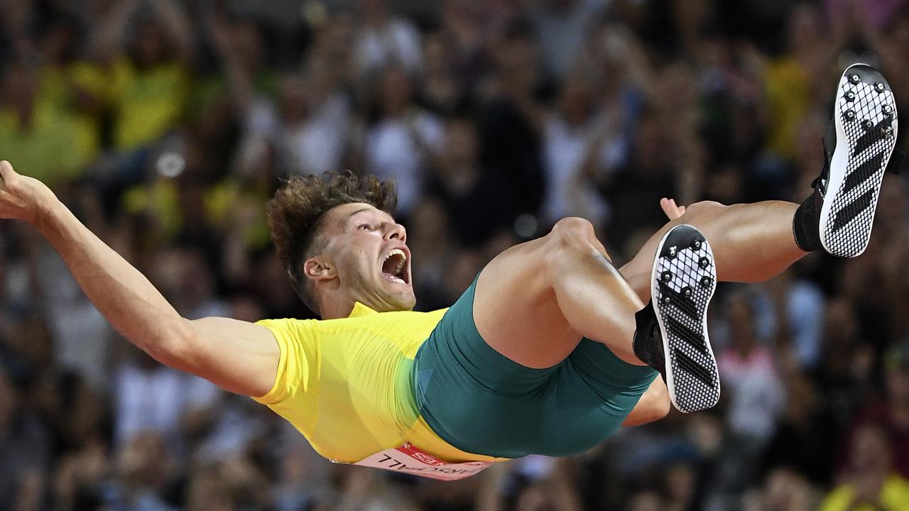 Kurtis Marschall of Australia celebrates as he falls to the mat after clearing 5m during the Men's Pole Vault Final on Thursday night.