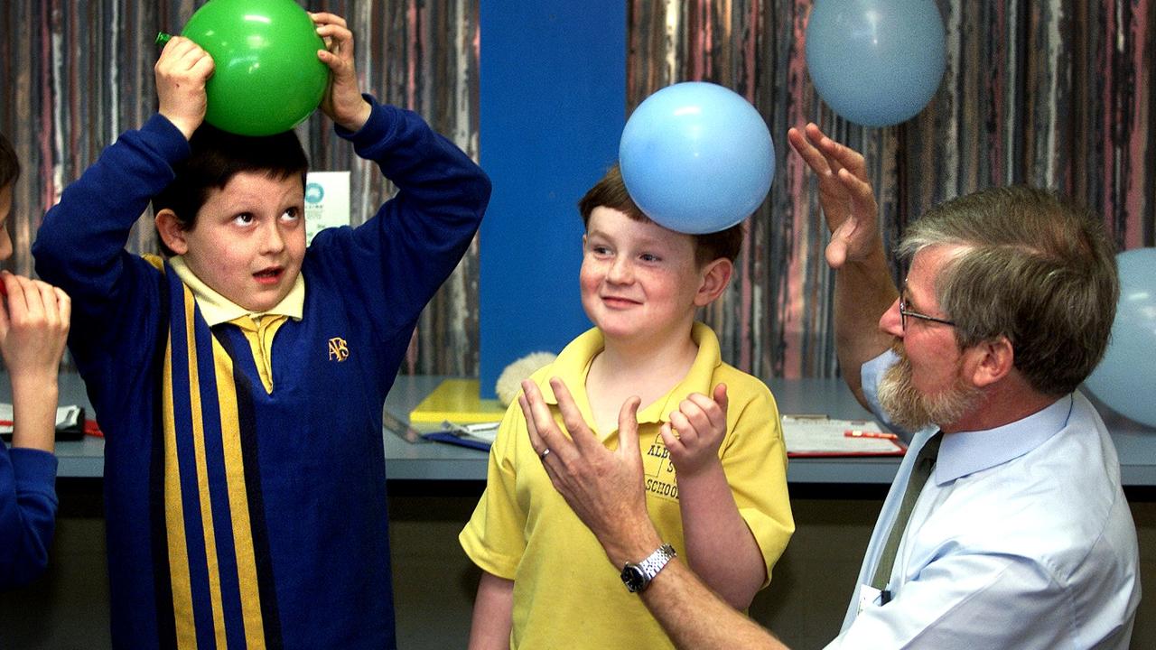 National Science Week CSIRO Science Education Centre balloon program Education Officer Richard Verrall guides Albuera Street Primary School students Roman Murphy and Mark Purdy through an experiment that shows the effects of static electricity