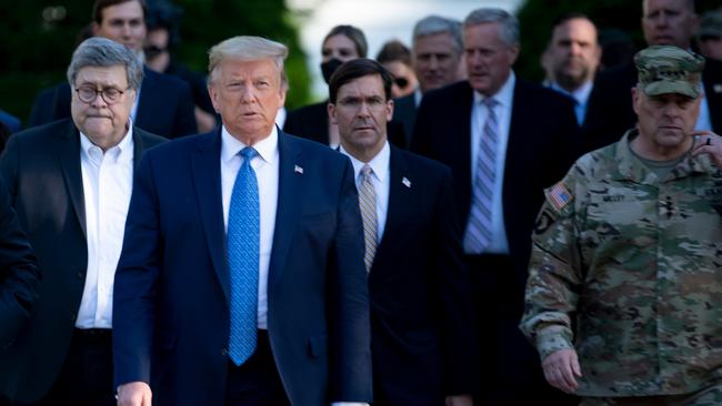 President Donald Trump walks with Attorney-General William Barr, left Secretary of Defence Mark Esper, centre, Chairman of the Joint Chiefs of Staff Mark Milley, right, and others from the White House to visit St John's Church.