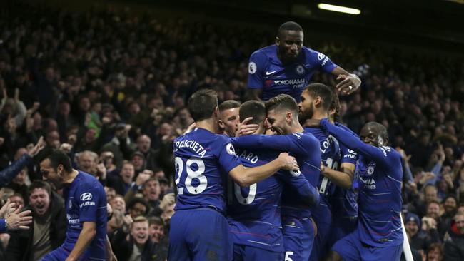 David Luiz is mobbed by his Chelsea teammates.