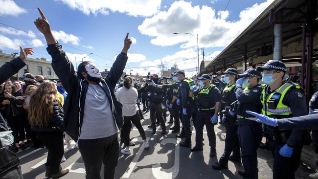 Police clash with protestors at a Melbourne Freedom Walk at Queen Victoria Market on Sunday. Picture: NCA NewsWire / David Geraghty