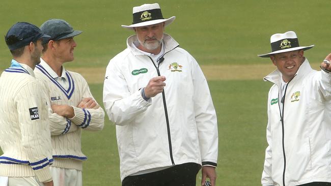 Kurtis Patterson (left) and Daniel Hughes of New South Wales speak with Umpires Paul Wilson (middle) and Sam Nogajski as rain halts play in the 2019 Sheffield Shield Final. Picture: AAP Image for Cricket Australia/Hamish Blair