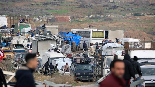 Displaced Palestinians wait to cross a checkpoint manned by Egyptian and US security on Salah al-Din road in al-Mughraqa in the central Gaza Strip. Picture: AFP.