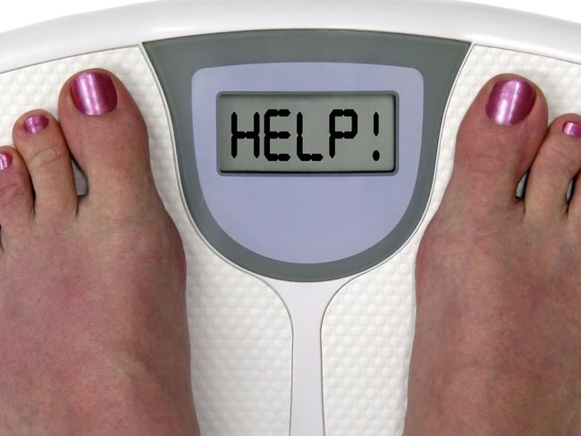 Feet on a bathroom scale with the word help! on the screen. Isolated. Includes clipping path.