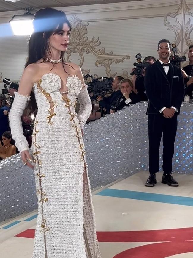 Actor Anne Hathaway on the red carpet at the 2023 Met Gala, as Formula One driver Daniel Ricciardo looks on in the background. Photo: Twitter