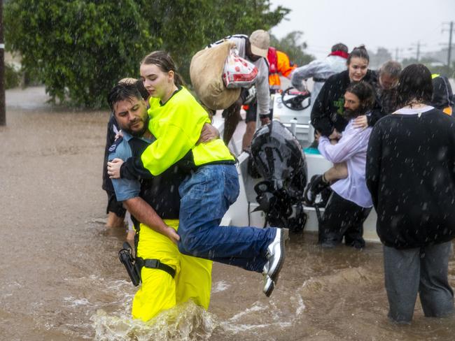 Lismore residents and emergency workers help rescue local people in the Richmond River area of NSW on Monday. Picture: MEDIA-MODE.COM