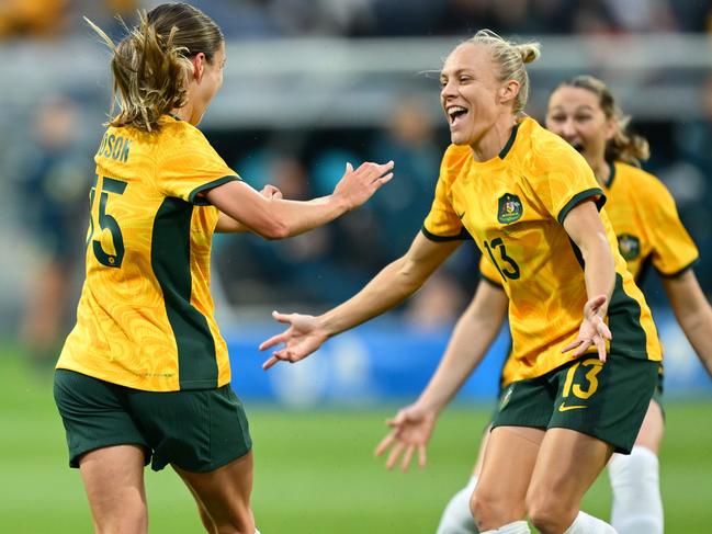 Leah Davidson celebrates with Tameka Yallop after scoring a goal.